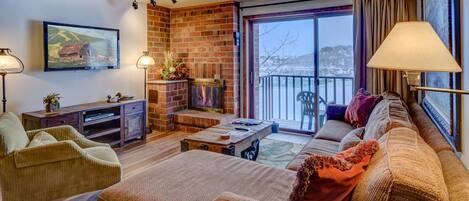 Living Area with Red Brick Fire Place and Sectional at Steamboat Rental