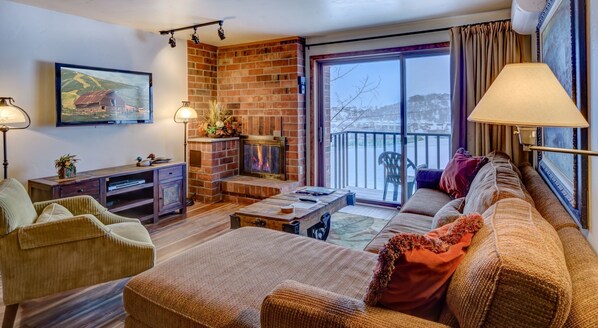 Living Area with Red Brick Fire Place and Sectional at Steamboat Rental