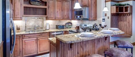 Kitchen of this Steamboat vacation rental, with breakfast island with seating and modern appliances.