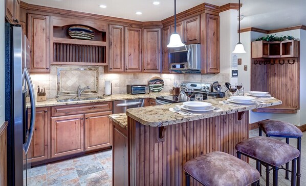 Kitchen of this Steamboat vacation rental, with breakfast island with seating and modern appliances.