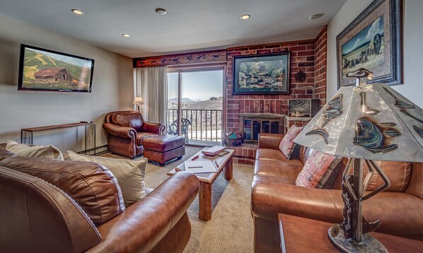 Living Room with a leather furniture set and a tv