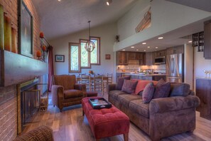 Living Room in the best condo in Steamboat Springs with a plush leather couch and ottoman in front of the fireplace.