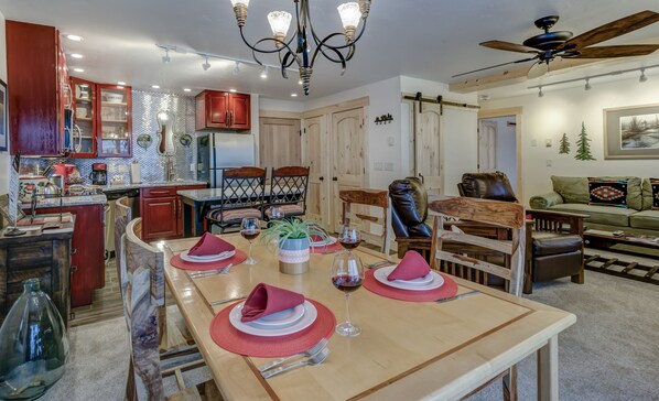 dining table with view into kitchen and living room