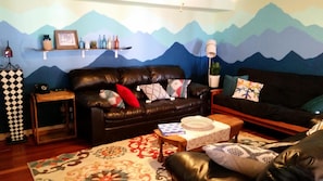 Mountain mural living room, decorated by reality show set designers