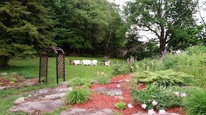 Backyard fire pit and flower gardens. Plenty of room for the kids to play!