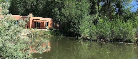 Adobe Casita on the half acre pond on our eco solar 8 acres of lush trails