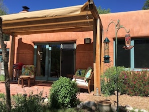 Hummingbirds and flowers surround the shaded outdoor private patio