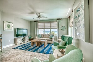 Living room with pull out queen sleeper, large flat screen and plenty of seating