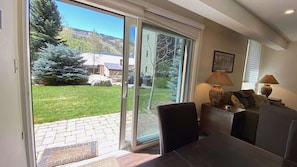 Walk out to patio and pool with views to Vail Mountain from dining area.