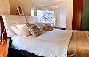 The foreshortened view of Rome rooftops from the king size bed