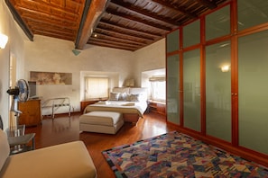 The king size comfortable bed under the coffered ceiling of the master bedroom