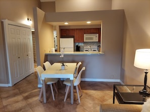 Dining area, kitchen and washer dryer closet in the hall