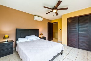 Master bedroom with A/C, ceiling fan, large closet, night tables and garden view