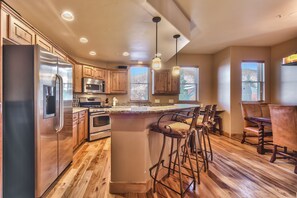 Fully Equipped Kitchen with Stainless Steel Appliances, Granite Countertops, Desk Area and Island Seating for 3