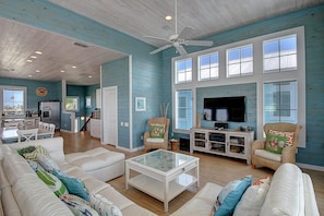 Indoor - Family room with tons of seating and access to the balcony