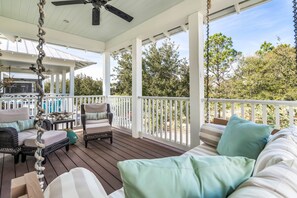 Spacious covered balcony with cushioned seating