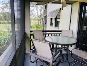 High table on screened lanai with beautiful view of golf course and lake