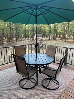 VIEW FROM OUTDOOR TABLE LOOKING AT WOODS