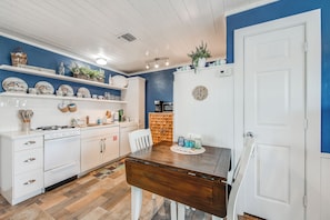 Small kitchen with gas stove, dishwasher, microwave, and refrigerator.