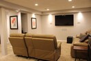 Downstair family room with power reclining leather sofas and surround sound.