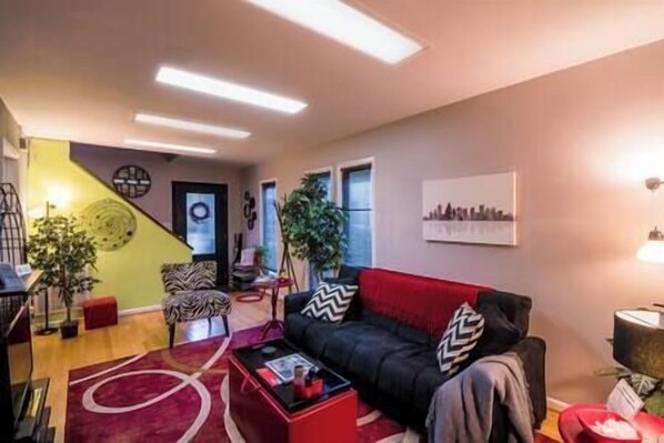 The Guest House living room offers plenty of seating, a large HDTV, and a sofa bed