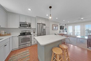 This kitchen is well equipped with a full-size refrigerator, oven, stovetop, microwave, dishwasher, and all the cookware and dishes you'll need to prepare and enjoy a meal.