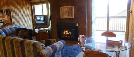 Living Room with gas Fireplace, small dining table.  