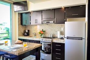 Bar & Kitchen with flatscreen TV for Living area.