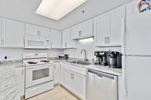 Beautifully Upgraded Kitchen with Granite Countertops and Seating at the Breakfast Bar