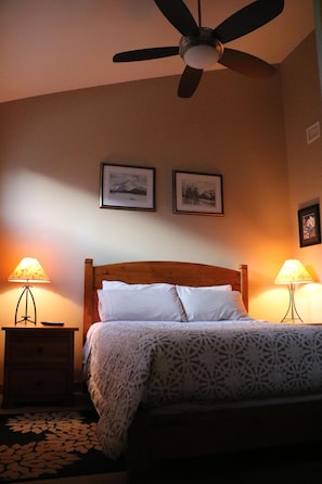 Loft bedroom with vaulted ceilings and ceiling fan