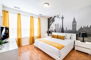 This  bedroom adorned with a captivating wall mural, where the iconic sights and bustling energy of the city come to life, creating a unique and inspiring ambiance.