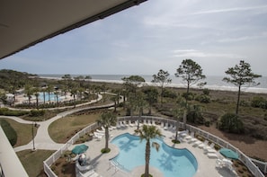 Balcony - Atlantic Oceanfront view , pool and tropical palm trees from balcony .