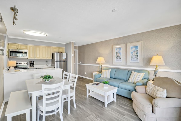 Living/dining area - Newly decorated unit.  Bright coastal colors with new flooring and furniture