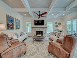 Main gathering room complete with 2 couches, 2 leather recliners and a giant tv!