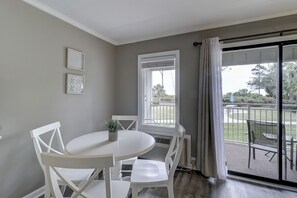 Ocean Dunes Villa 119 - Dining area - You enjoy a view of the courtyard and pool through the sliding doors to the balcony.