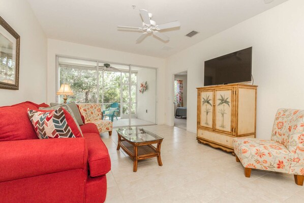 The sliding glass door across the back of the condo allows for a full view of the nature preserve, while you realx and enjoy the large screen Smart TV