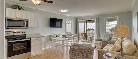 Kitchen and Dining area - The Living Room Area has sliding door access to the Pool/Ocean view Balcony. Upscale furnishings and a wall mounted flat screen television complete the space.