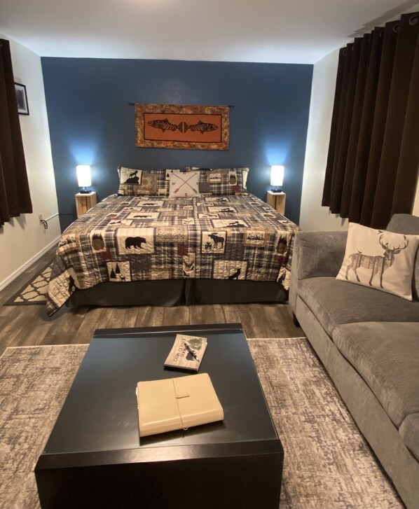 Living area with king sized bed behind. 