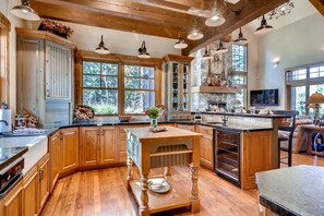 Expansive chef's kitchen with chopping block island and dedicated wine cooler