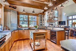 Expansive chef's kitchen with chopping block island and dedicated wine cooler