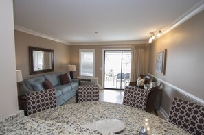 Dining /Living room Area - The newly renovated completely furnished Kitchen features all stainless steel appliances, beautiful granite counters and dining bar seating for four . Living room offers comfy sofa bed, wall mounted smart flat screen T.V. and sliding door to balcony with amazing Beachfront view and Palm trees.