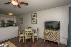 Kitchen and Dining area - The newly renovated completely furnished Kitchen features all stainless steel appliances, beautiful granite counters.  Dining table seats four. The living room has a comfy sofa bed, wall mounted smart flat screen T.V. and sliding door to balcony with amazing Beachfront view and Palm trees.