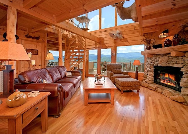 Open floor-plan living room with wood fireplace.