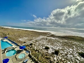 View of the pool area and Gulf from our balcony!
