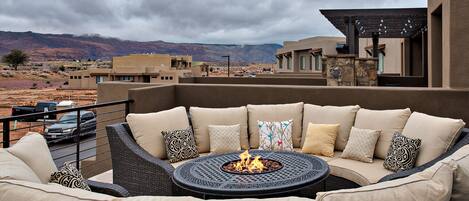 Front Patio Deck View & Firepit - Stay warm next to the firepit and relax while watching the sunset over the red mountains.