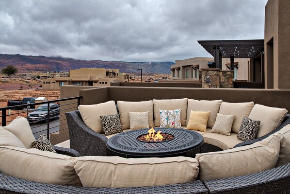 Front Patio Deck View & Firepit - Stay warm next to the firepit and relax while watching the sunset over the red mountains.