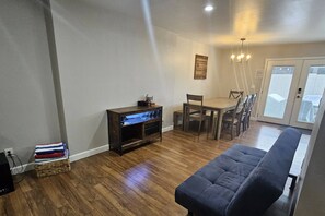 Barcart and futon just off the kitchen and living room
