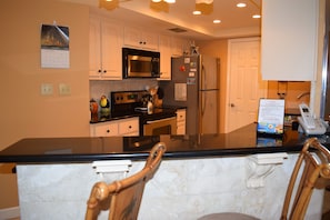 Looking across the high bar, the back splash and front to this counter is coral.