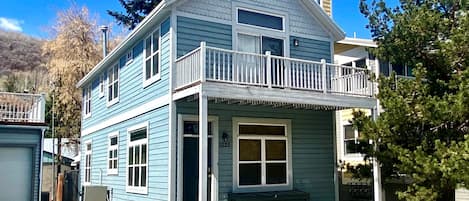 Old Town Retreat private home with white portico and second level patio