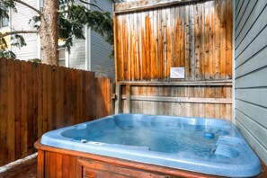 Nice hot tub on the deck surrounded by wooden privacy fence